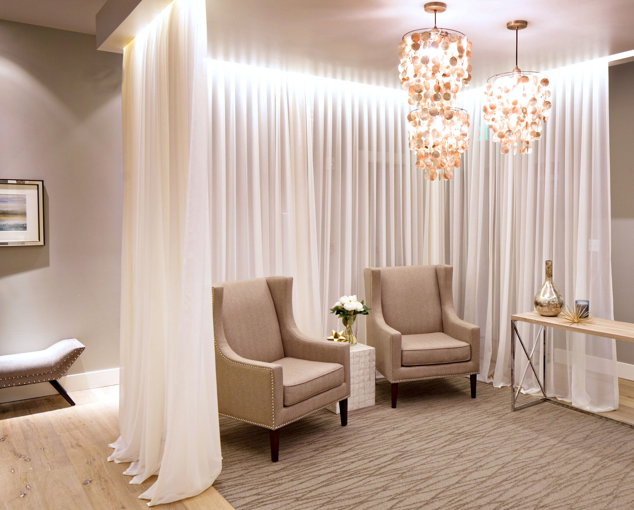 Two Chairs And A Table In A Room With Drapes On The Wall Behind Them pertaining to Med Spa Interior Design Ideas